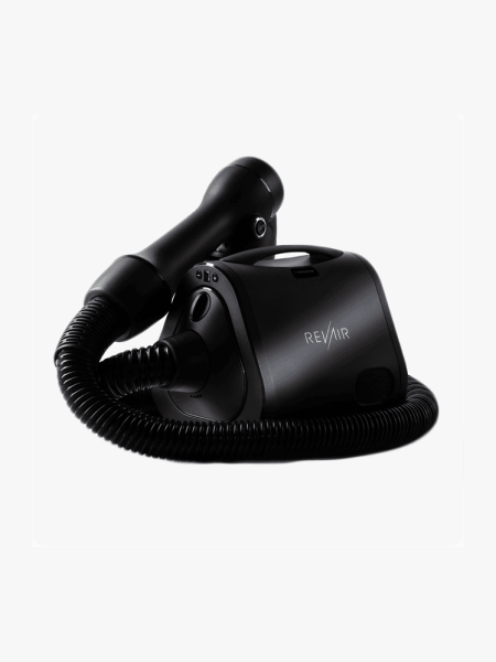 Revair branded black reverse air hair dryer on light gray background